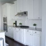 Custom White cabinet, stained flooring and new countertop installation.