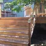 Custom cedar deck with wide stairs installation.